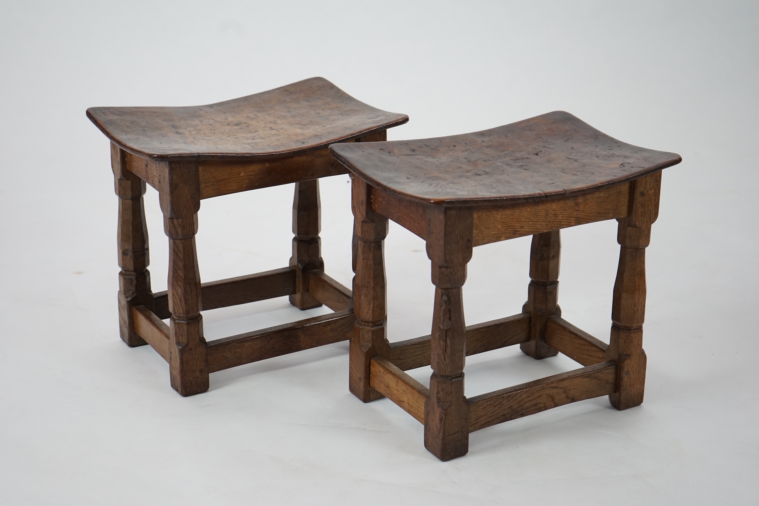 A pair of Robert 'Mouseman' Thompson burr oak stools, 1930s